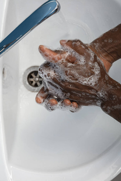 Man washing hands carefully in bathroom close up. Prevention of infection and pneumonia virus spreading - Fotografie, Obrázek