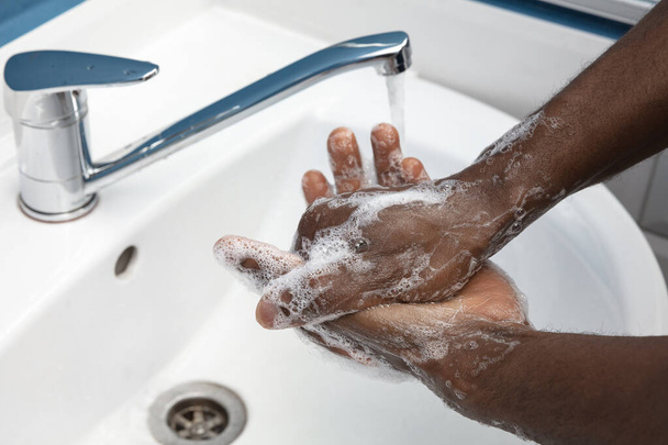 Man washing hands carefully in bathroom close up. Prevention of infection and pneumonia virus spreading - Foto, Imagem