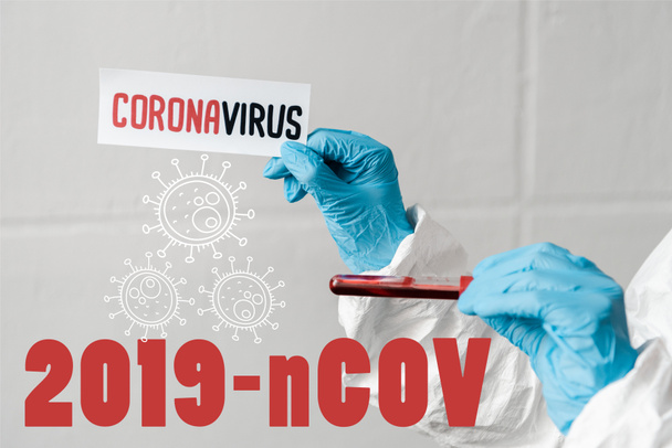 cropped view of person in latex gloves holding coronavirus card and blood sample, 2019-ncov illustration - Photo, Image