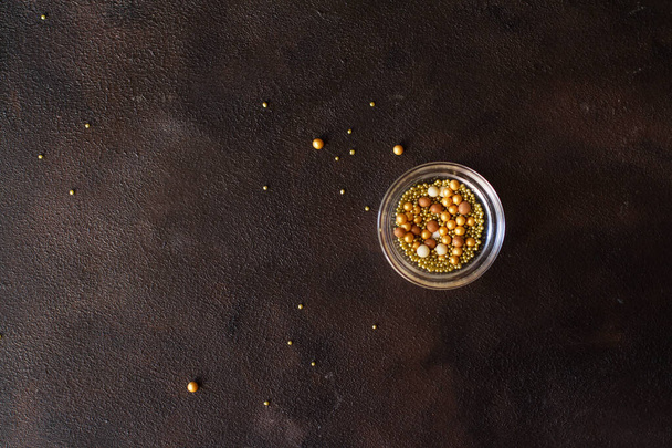 Cup with sprinkles on a dark background. - Foto, afbeelding