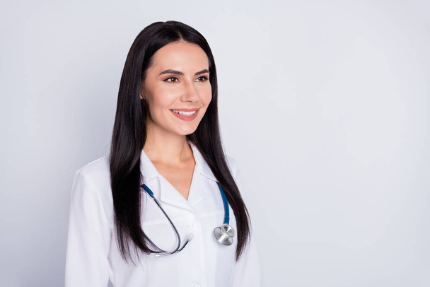 Photo of attractive professional doctor practitioner intern lady good mood friendly smiling looking patient wear white lab coat stethoscope isolated grey color background - Foto, afbeelding