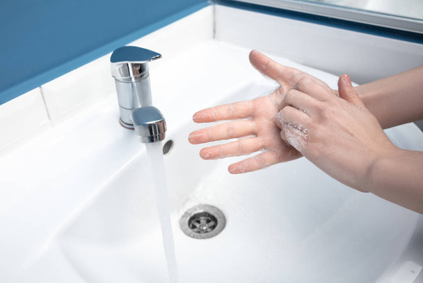 Woman washing hands carefully in bathroom close up. Prevention of infection and pneumonia virus spreading - Foto, Bild