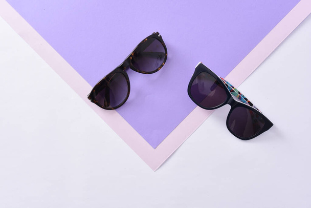 gafas de sol gafas de vista sobre fondo de papel color pastel
  - Foto, imagen