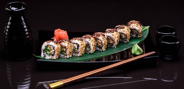 Rollo de sushi sobre fondo negro
 - Foto, imagen