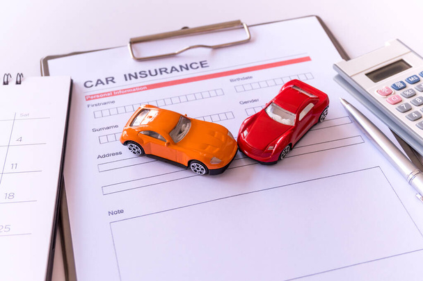 Car insurance form with model and policy document  - Photo, Image
