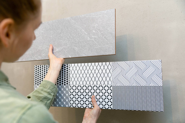 woman choosing wall tiles for her new bathroom interior design - Valokuva, kuva