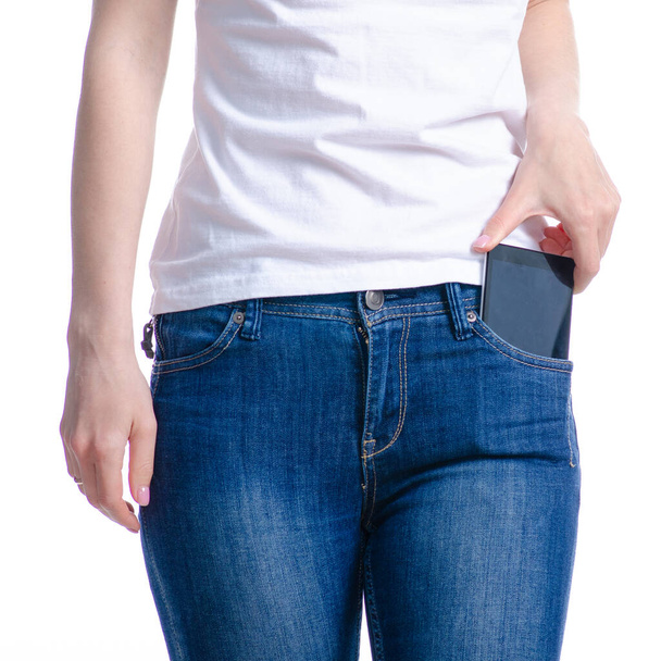 Woman puts mobile phone in jeans pocket - Foto, Imagen