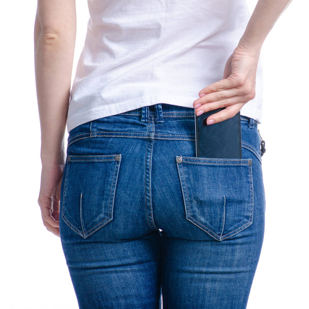 Woman puts mobile phone in jeans pocket - Fotografie, Obrázek