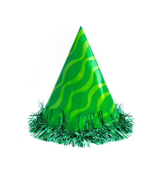 Green party cap made of paper, isolated on white background. Holiday cup, carnival accessory with tinsel. - Photo, Image