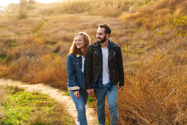 Image of beautiful young caucasian couple dating and walking together in countryside - Fotografie, Obrázek