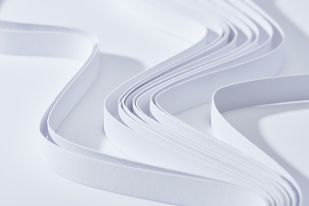 Beyaz arkaplanda dalgalı kağıt şeritlerin görüntüsünü kapat - Fotoğraf, Görsel