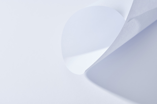 close up view of curved paper sheet on white background - Zdjęcie, obraz