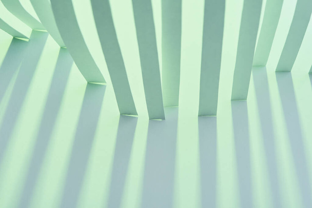 close up view of paper stripes with shadow on green background - Zdjęcie, obraz