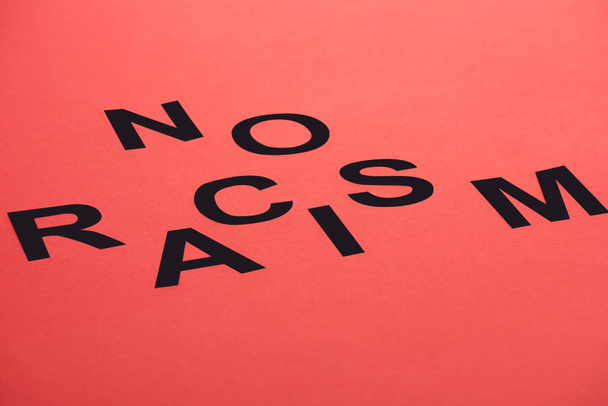 black no racism lettering isolated on red - Φωτογραφία, εικόνα