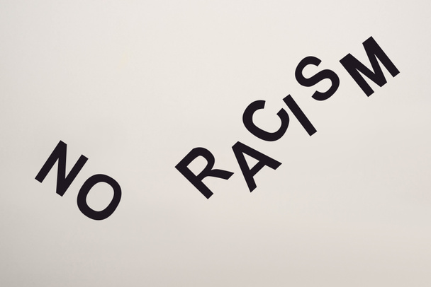 top view of black no racism lettering isolated on white - Fotó, kép