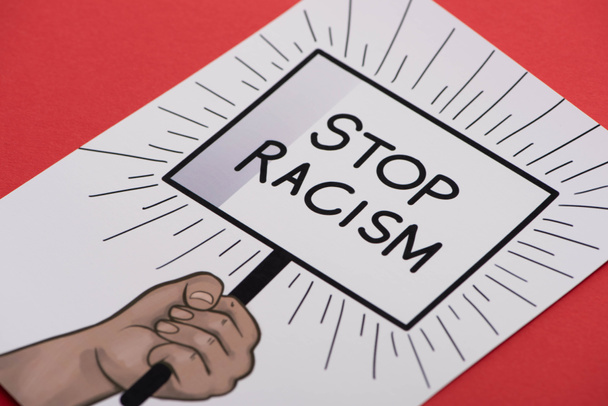 picture with drawn hand and stop racism placard on red background - Fotografie, Obrázek