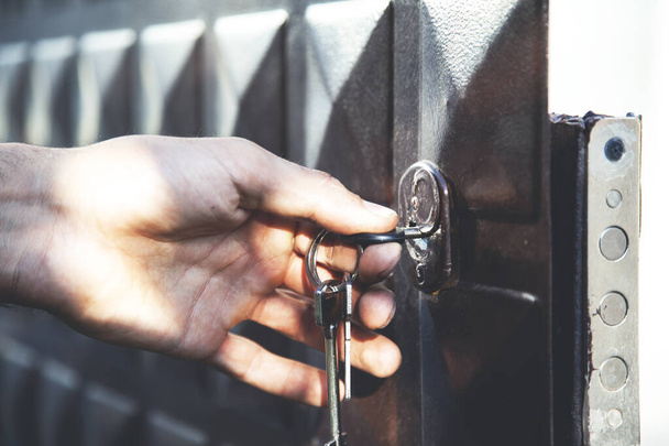man hand holding key with garage door - Photo, Image