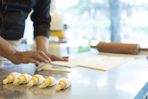 man at kitchen making croissant  - Valokuva, kuva