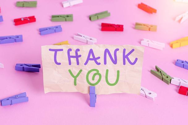 Text sign showing Thank You. Conceptual photo a polite expression used when acknowledging a gift or service Colored clothespin papers empty reminder pink floor background office pin. - Photo, Image