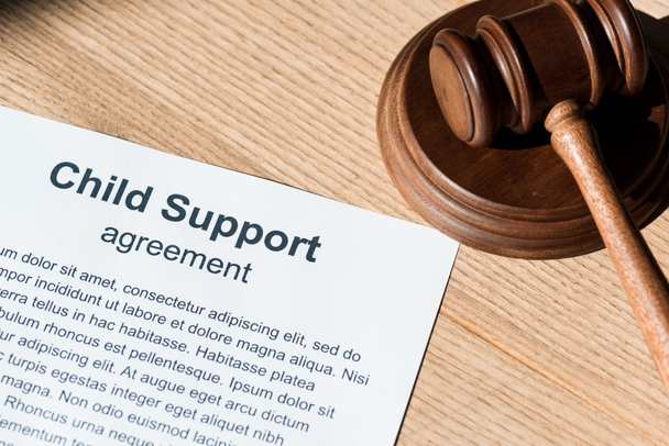 wooden gavel near document with child support agreement  - Foto, imagen
