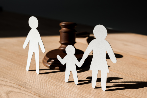 paper people near wooden gavel on table, divorce concept  - Photo, Image