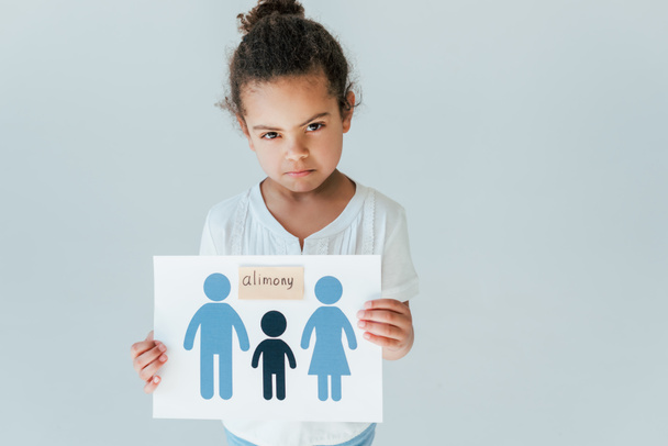 upset african american kid holding paper with drawn family and alimony lettering isolated on white - Fotografie, Obrázek