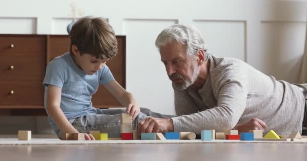 Happy middle aged man playing with grandson at home. - Imágenes, Vídeo
