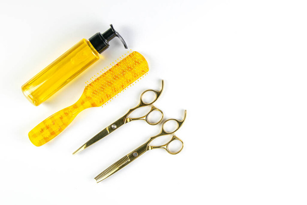 Hair gel, comb and scissors for haircut stand on a white towel which stands on a white background. - Photo, Image