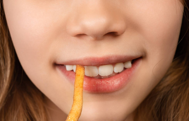 mouth teenage girl eating French fries closeup. - Foto, Imagem