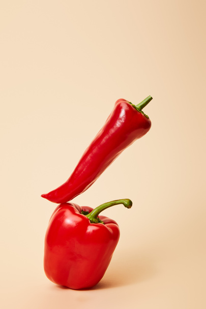 red chili pepper on bell pepper on beige  - Photo, Image