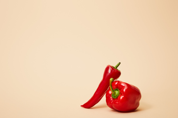 ripe chili and bell peppers on beige with copy space - Фото, зображення