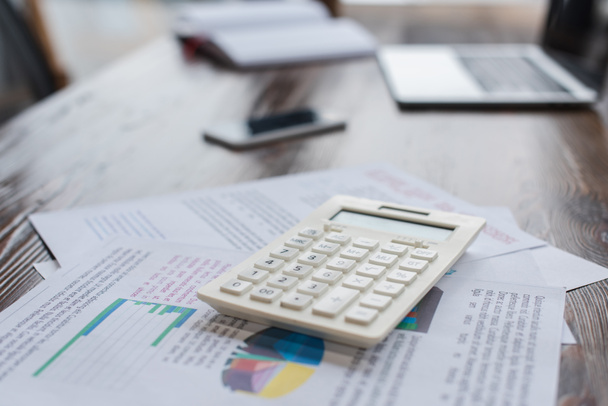 Calculator with papers on table in office - Foto, imagen