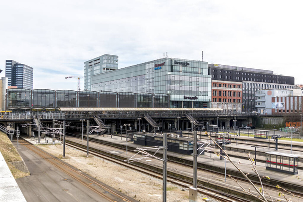 Aarhus, Danimarka - 24 Mart 2020: Aarhus tren istasyonu köprünün altından geçiyor. Bruun 'un galeri alışveriş merkezi arka planda görülüyor. Bisiklet parkı köprüde görülebilir. Comwell Oteli solda. - Fotoğraf, Görsel