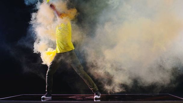 young man dancing with color smoke  - Photo, Image