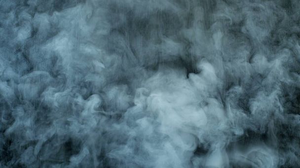 Photo of Realistic Clouds, fog, fume, haze, mist, vapor, smoke, dry ice smoke on black dark Background. Poster, Wallpaper, Texture, Banner, Still design. - Zdjęcie, obraz