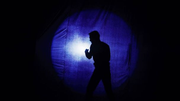 Staging of the battle of two guys, comedy, comedian boxing behind the curtain. Silhouettes of two comic fighting guys. A parody of the battle. It is convenient to use both maniac documentary stories. - Photo, Image