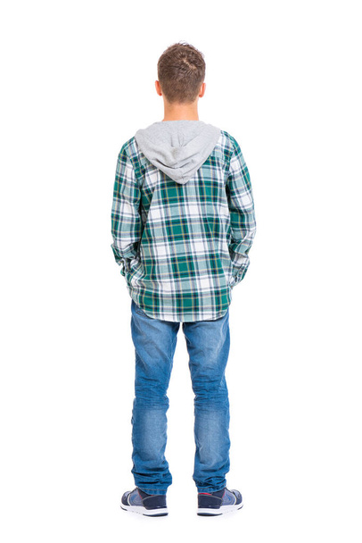 Full length portrait of young caucasian teen boy - rear view, isolated on white background. Funny teenager - back view. Handsome child with hands in pockets. - Φωτογραφία, εικόνα