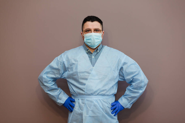 doctor wearing respiratory mask coronavirus epidemic with protective gesture. Healthcare concept - Zdjęcie, obraz
