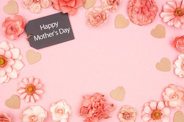 Happy äitienpäivä liitutaulu lahjakortti runko vaaleanpunainen paperi kukkia. Top näkymä vaaleanpunainen tausta. Kopioi tila
. - Valokuva, kuva