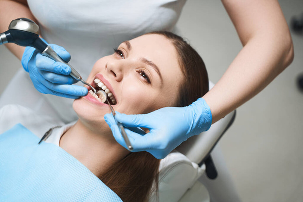 Young woman treating teeth in clinic stock photo - Photo, Image