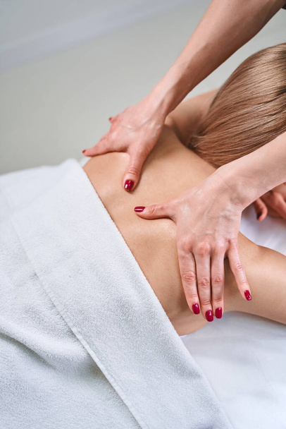 Professional practitioner doing massage for healthy back - Fotoğraf, Görsel