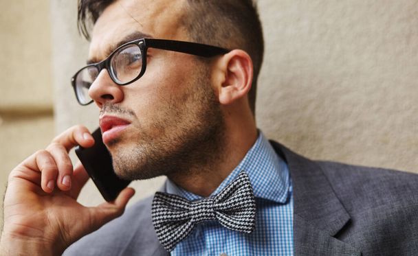 stylish businessman talking on the phone on the street - Photo, Image