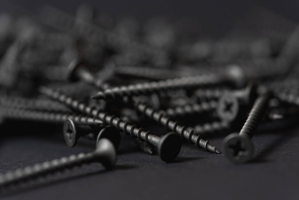 black wood screws on dark backgroun  - Fotografie, Obrázek