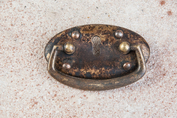 Antique brass drawer pull knob on concrete background. Copy space for text. - Photo, Image