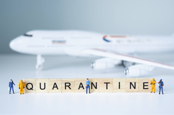 Group of toy people isolate a plane and its passengers. Quarantine concept. - Fotografie, Obrázek