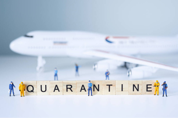 Group of toy people isolate a plane and its passengers. Quarantine concept. - Zdjęcie, obraz