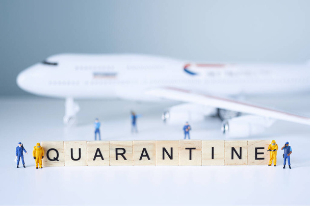Group of toy people isolate a plane and its passengers. Quarantine concept. - Φωτογραφία, εικόνα