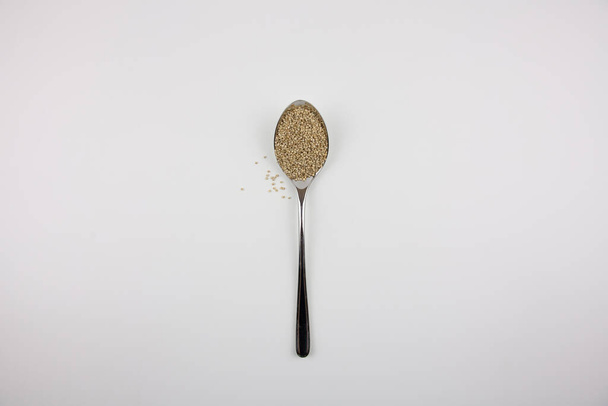 Quinoa Iron Spoon on white background - Φωτογραφία, εικόνα