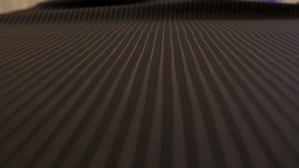 close up of a pin-striped cloth fabric waving. cloth for Men's suit at tailor's shop to make jacket for wardrobe. Bespoke tailor working at a factory for wedding formal costume. - Footage, Video