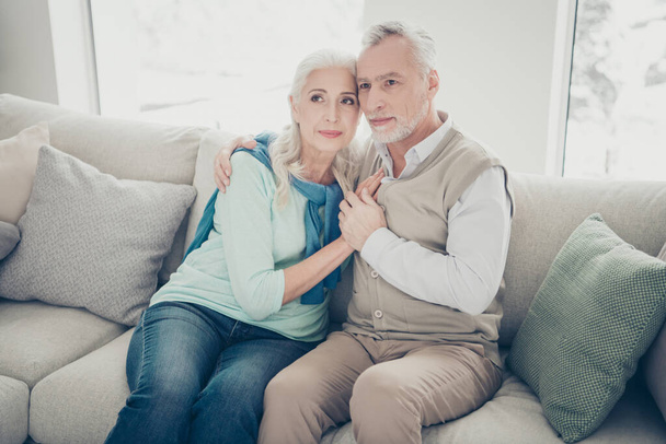 Photo of two pretty aged people pair leaning heads family portrait sitting cozy sofa indoors - Foto, Imagem